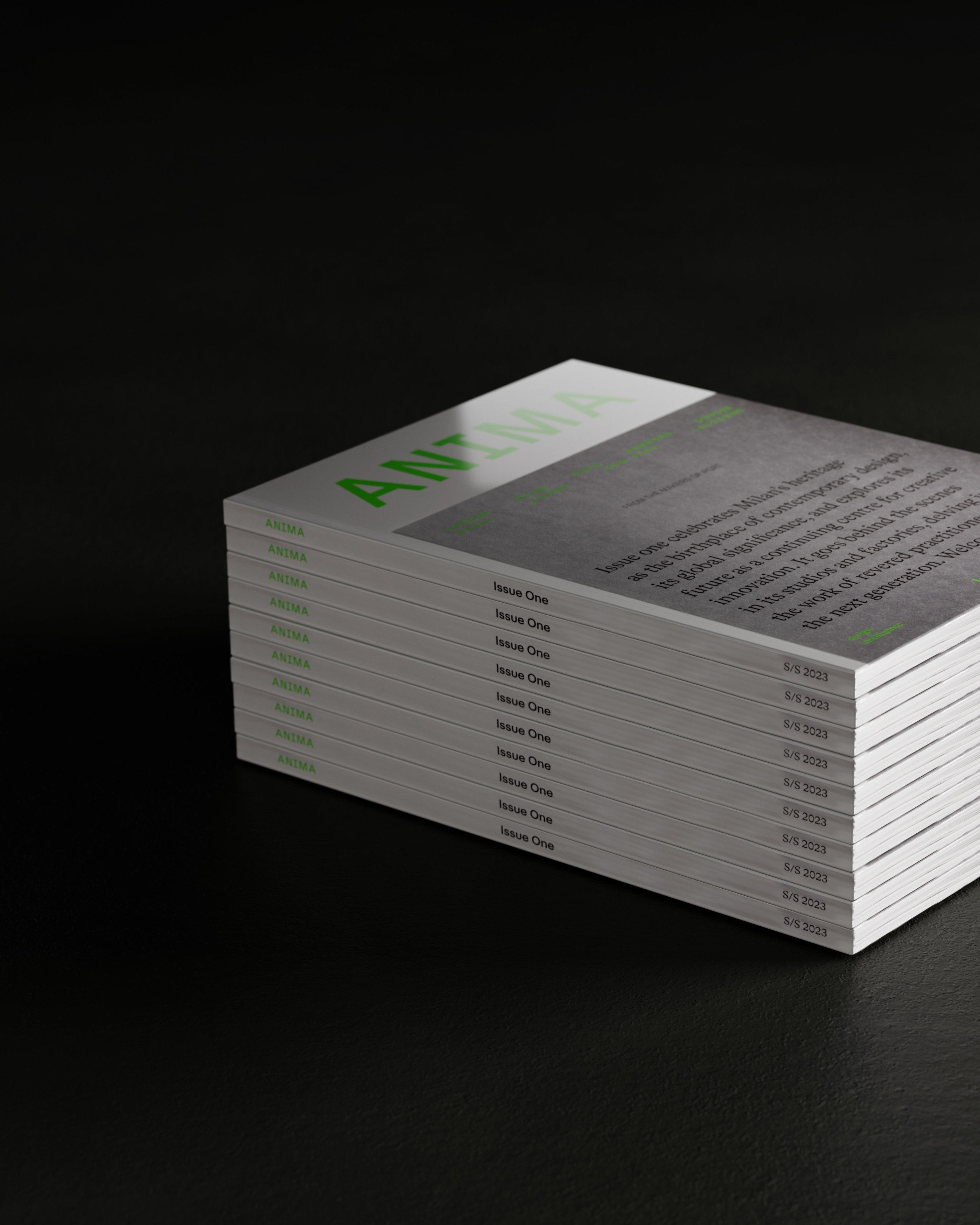 A stack of copies of Anima magazine on dark background.